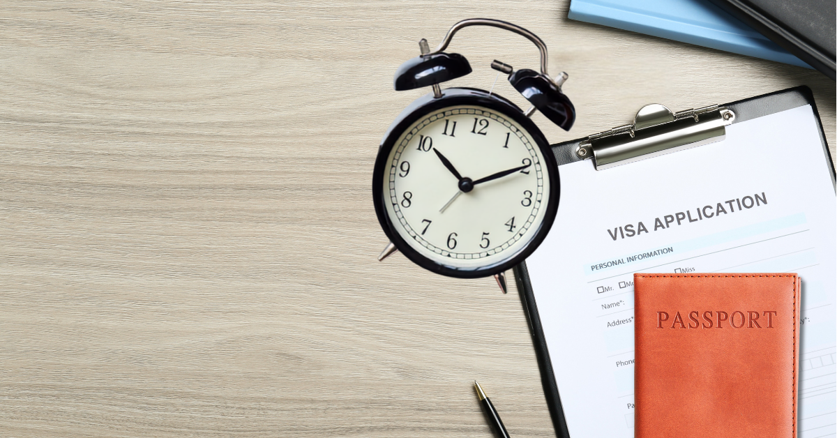 Visa application form, passport and alarm clock representing UK visa processing times and application delays.